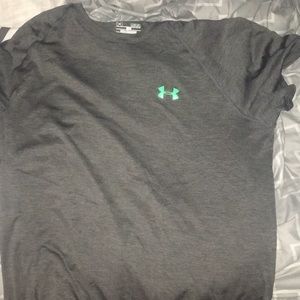 A grey and green logo under armour shirt